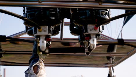 close-up of hot air balloon burners and pilot's hand