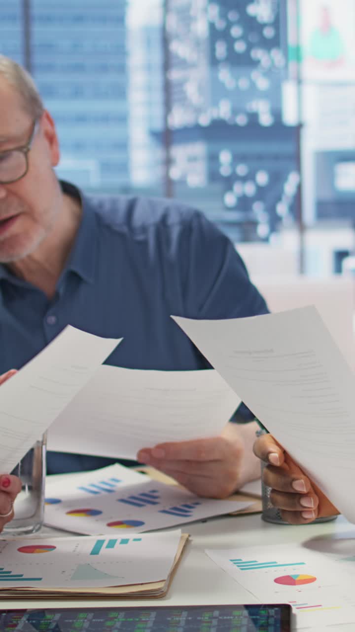 Vertical Video Elderly people exploring a detailed pension plan with financial advisor