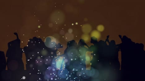 animation of blue and green bokeh lights and glowing particles over dancing crowd