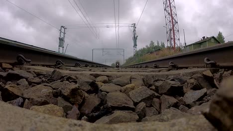 A-very-old-steam-engine-train-riding-over-a-camera-on-tracks