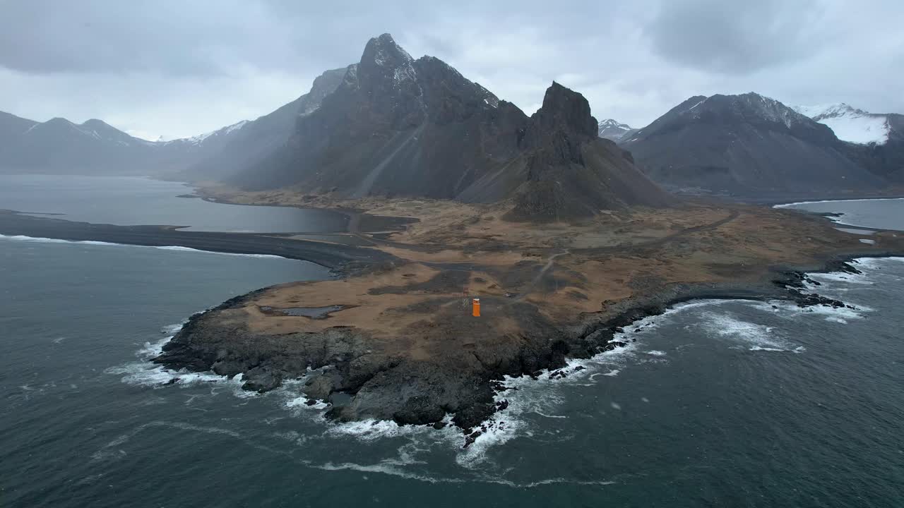 Iceland Dramatic Coastline in the Eastern Fjords with Orange Lighthouse on Iceland's Ring Road