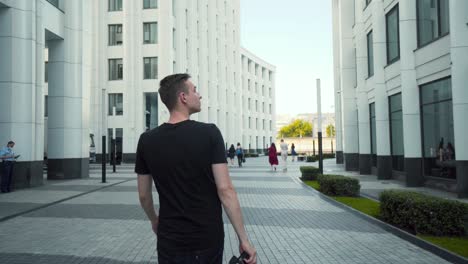 photographer walking in a modern city plaza