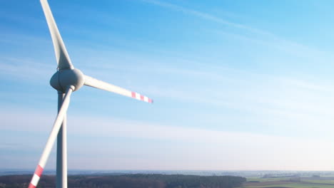 Close-up-wind-turbine-in-suny-day-and-clean-sky-with-small-clouds