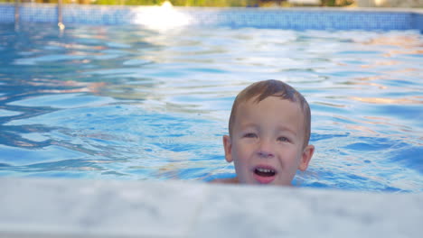 cute little child bathing in outdoor swimming pool