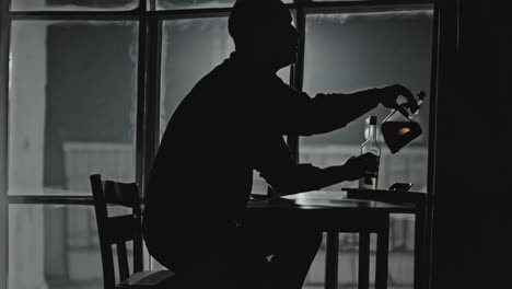 man drinking alone at night