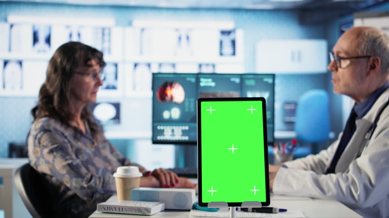 Vertical Video Experienced physician doing check up routine with patient next to chroma key