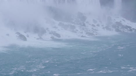 Mist-slowly-rises-from-the-bottom-of-the-American-side-of-Niagara-Falls,-on-a-gloomy-day