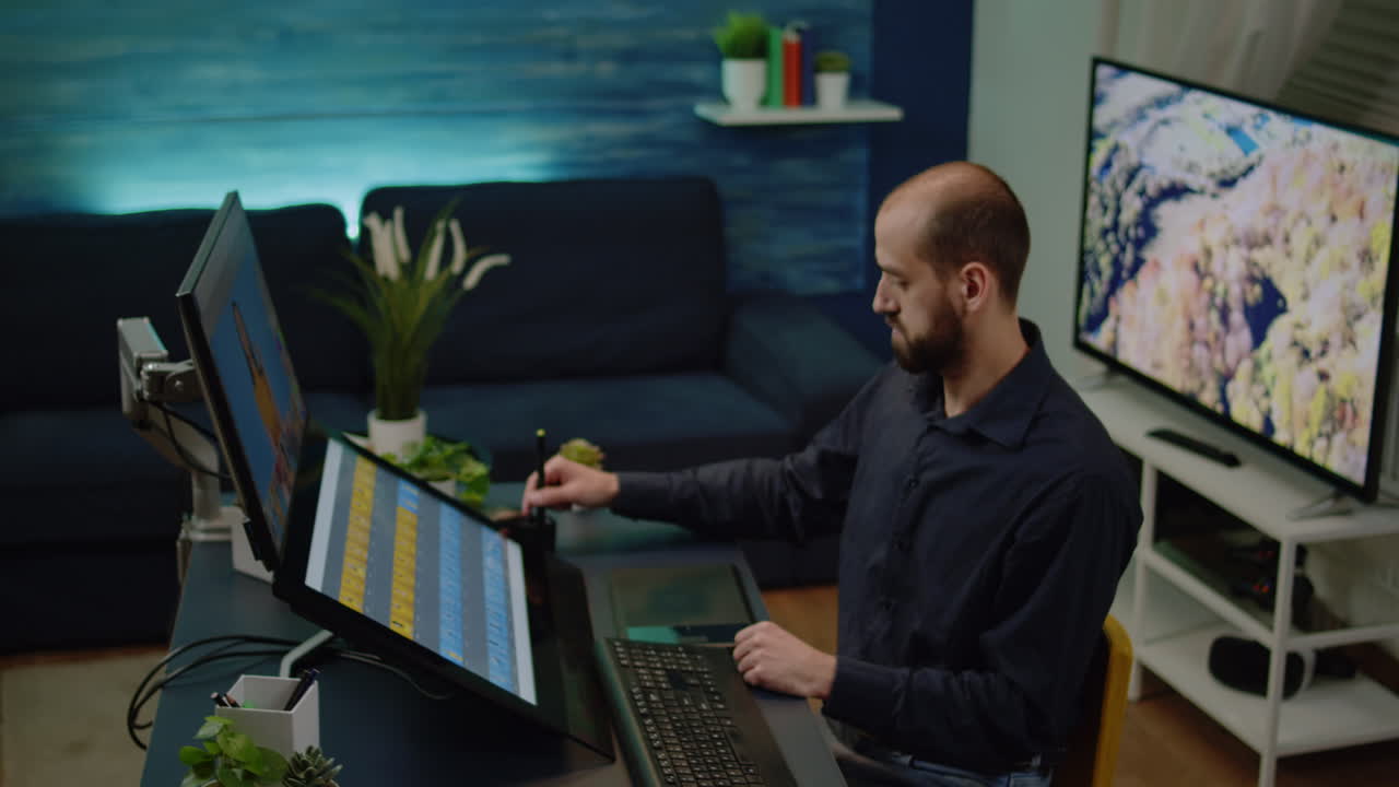 Male photographer doing editing work on touch screen