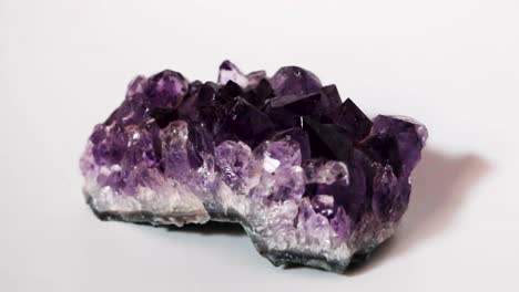 still shot of purple amethyst druse crystal in white background