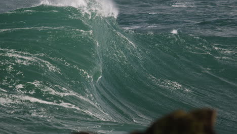 heavy wave folding onto a shallow reef break in australia