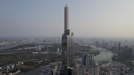 landmark 81 tower in ho chi minh city, saigon, the highest building in vietnam - aerial backward moving drone shot