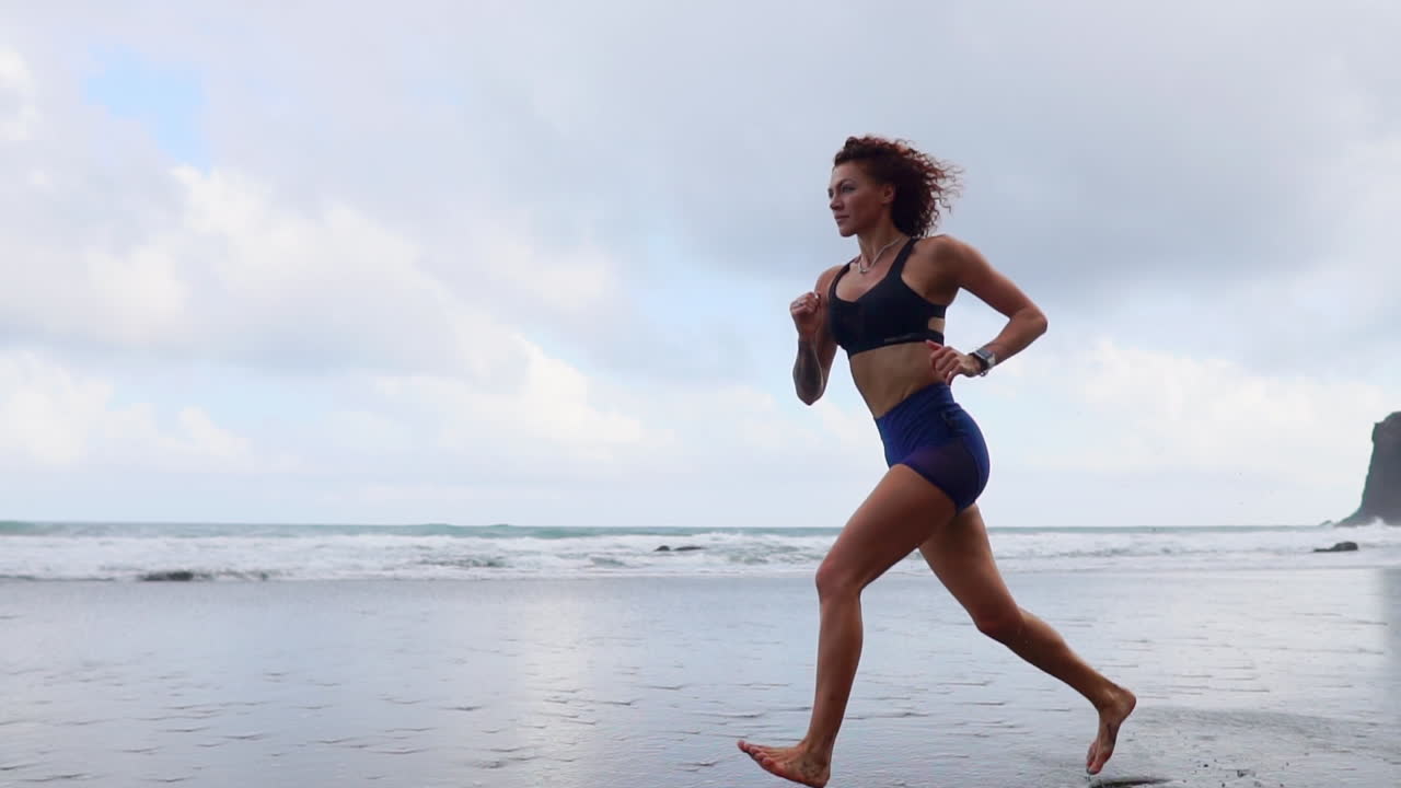 Sculpting the Silhouette: Slow Motion Morning Run of a Curvy Athlete by the Ocean
