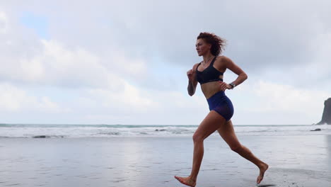 sculpting the silhouette: slow motion morning run of a curvy athlete by the ocean