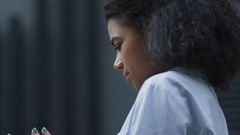 Smiling-woman-texting-friend-standing-at-modern-office-building-alone-closeup.