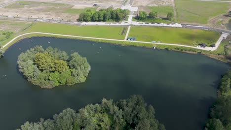 soaring above a calm lakefront, this aerial drone footage captures serene waters and natural landscapes, perfect for travel, nature, and outdoor footage.