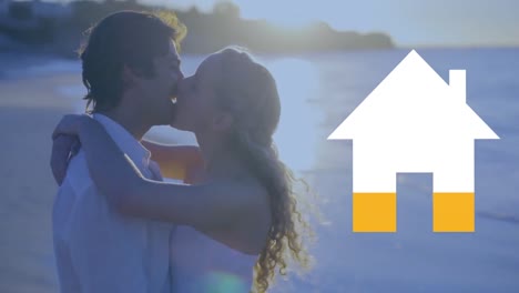 pareja feliz en la playa y el icono de la casa llenando de amarillo