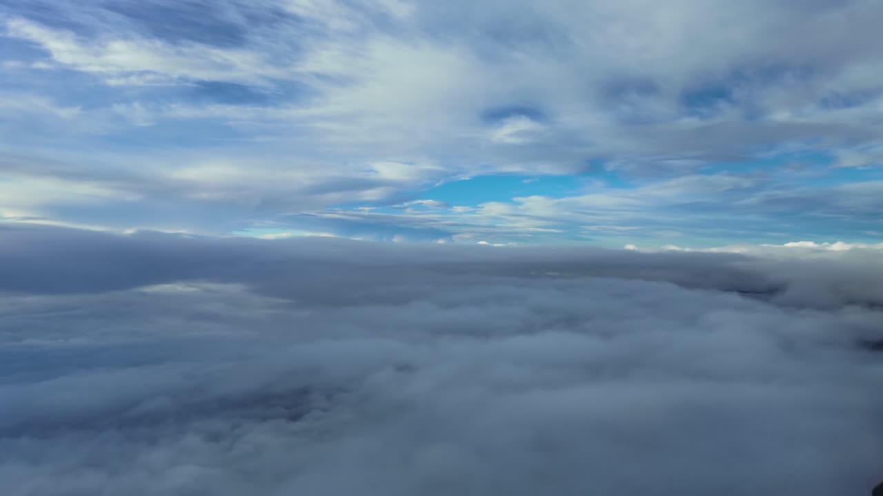 Immersive fighter jet pilot’s eye view while flying through layers of stratus clouds in a cold winter day during the descent