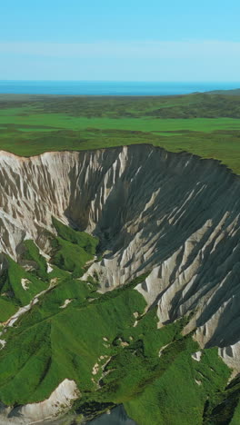 aerial view of a valley with a canyon and lush green vegetation