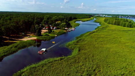 People-Riding-Traditional-Boat-Cruising-In-The-Lielupe-River-During-Sightseeing-Trip-In-Latvia