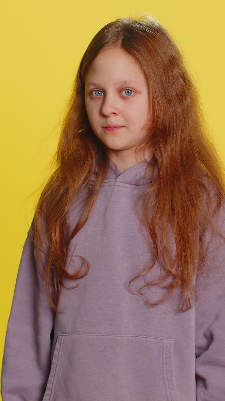 Frightened child girl closing mouth with hands refusing to tell terrible secret unbelievable truth