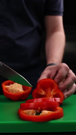 chef chopping red bell peppers