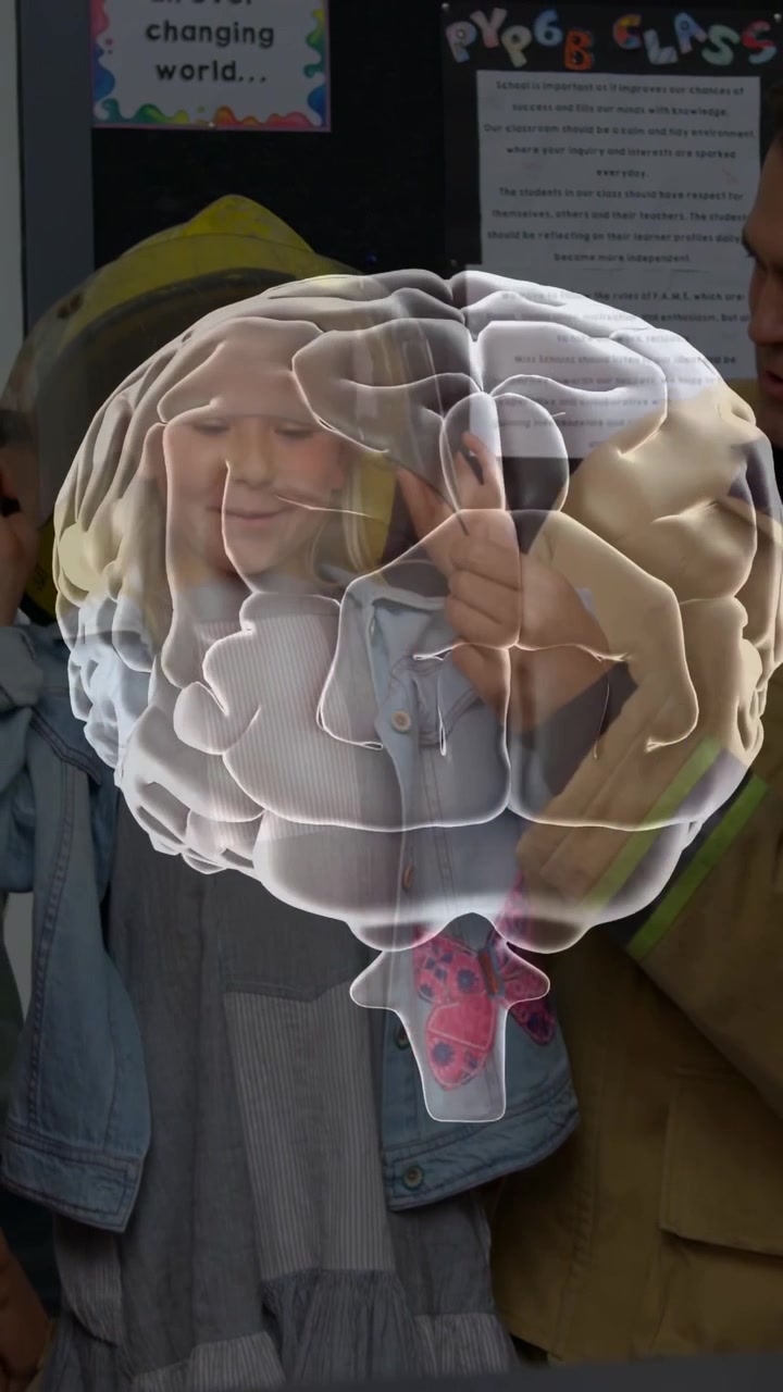 Vertical video: 3D brain popping over kids rotating while kids tracing for education, adult guiding