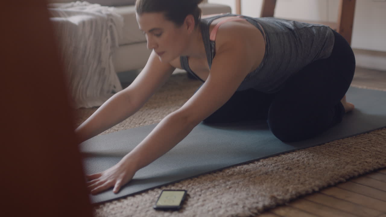 mujer de yoga saludable haciendo ejercicio en casa practicando la pose de los niños en la sala de estar disfrutando del ejercicio físico matutino