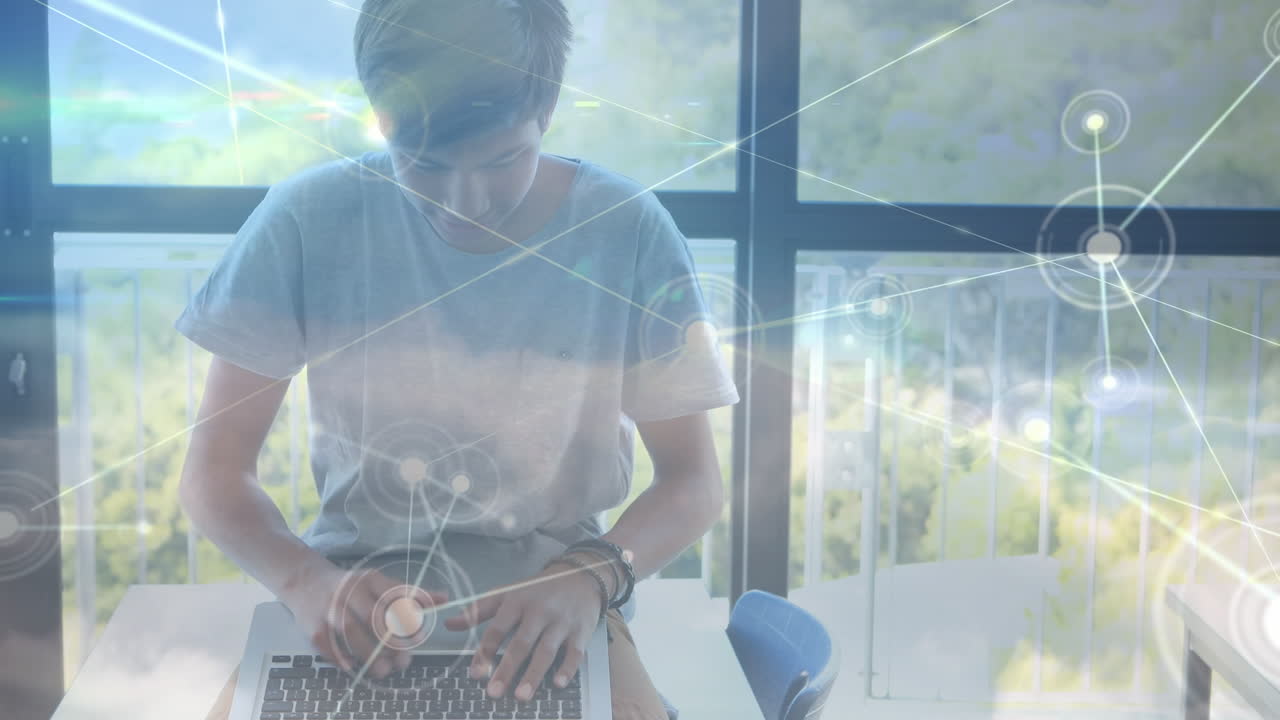 Animation of network of connections over biracial student using laptop