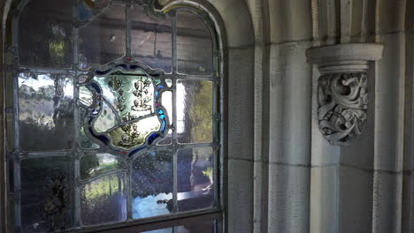 leaded glass window and ornate gothic stonework detail