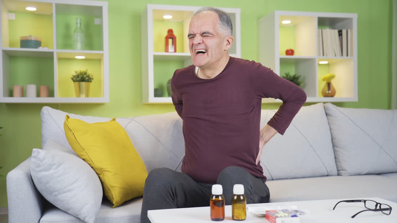 Elderly man with back, waist and knee pain. Aging problems.