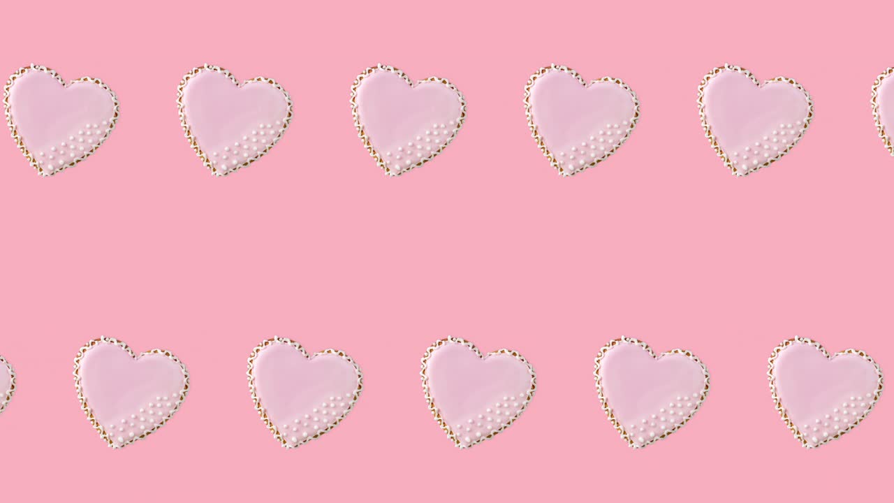 파스텔색 배경에 분홍색 글레이즈로 장식된 두 줄의 심장 모양의 쿠키와 함께 원활한 루프 애니메이션