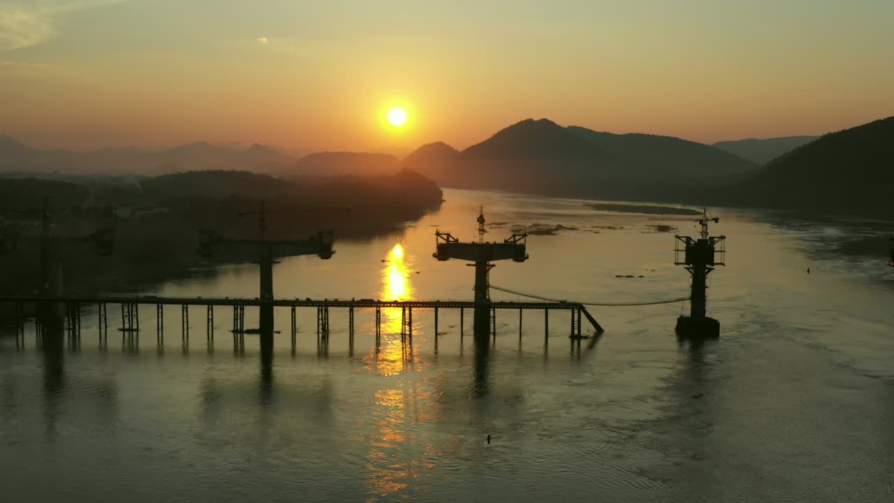 Sunrise over River Bridge Construction