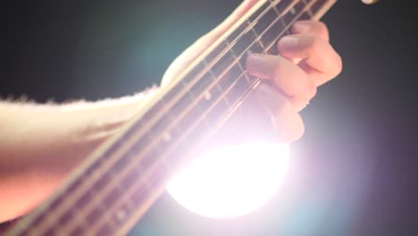 bass guitar fretboard with a person playing a bass riff