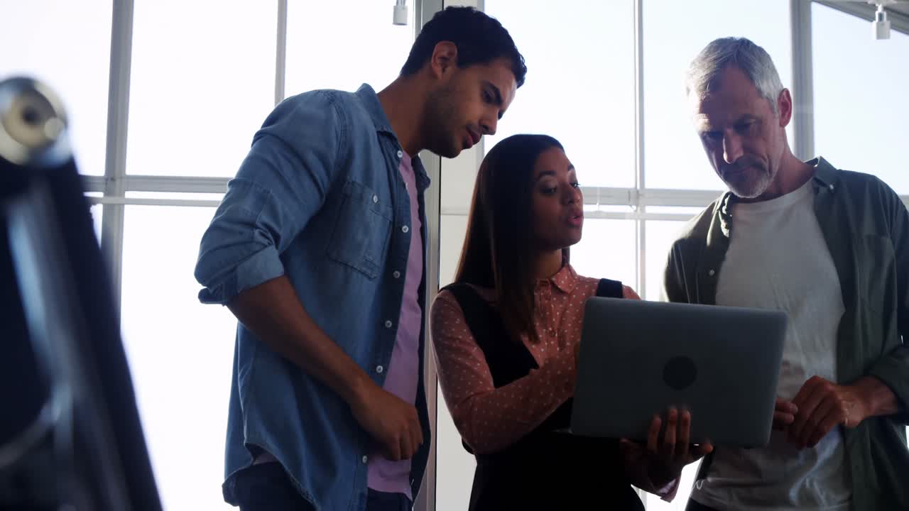 Business colleagues discussing over laptop in the meeting 4k
