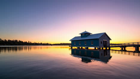 boathouse on a calm lake at sunrise