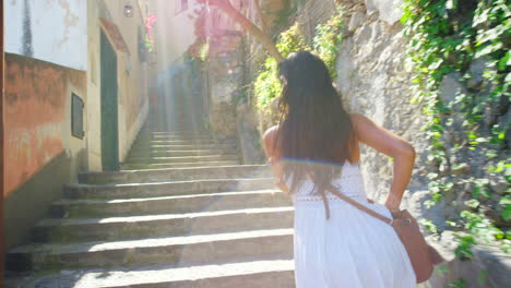 A-cheerful-young-woman-running-up-a-set-of-stairs