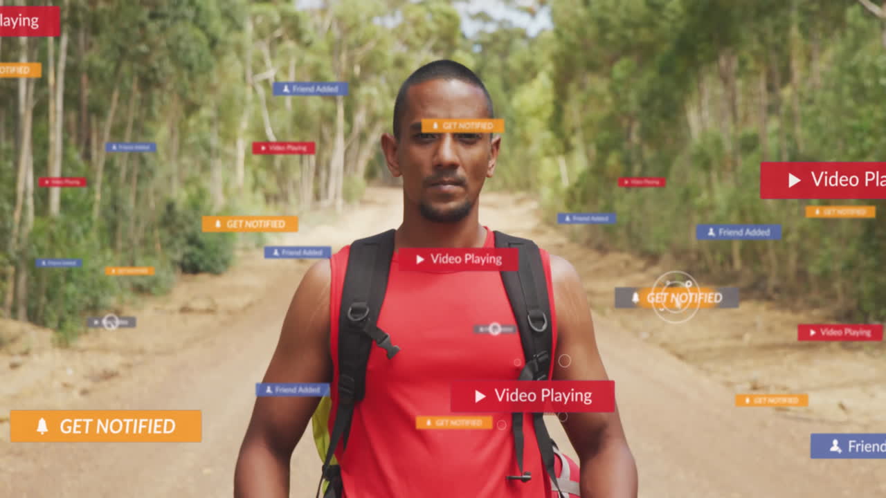 Animation of notification icons over biracial man with bag pack standing on trails in forest