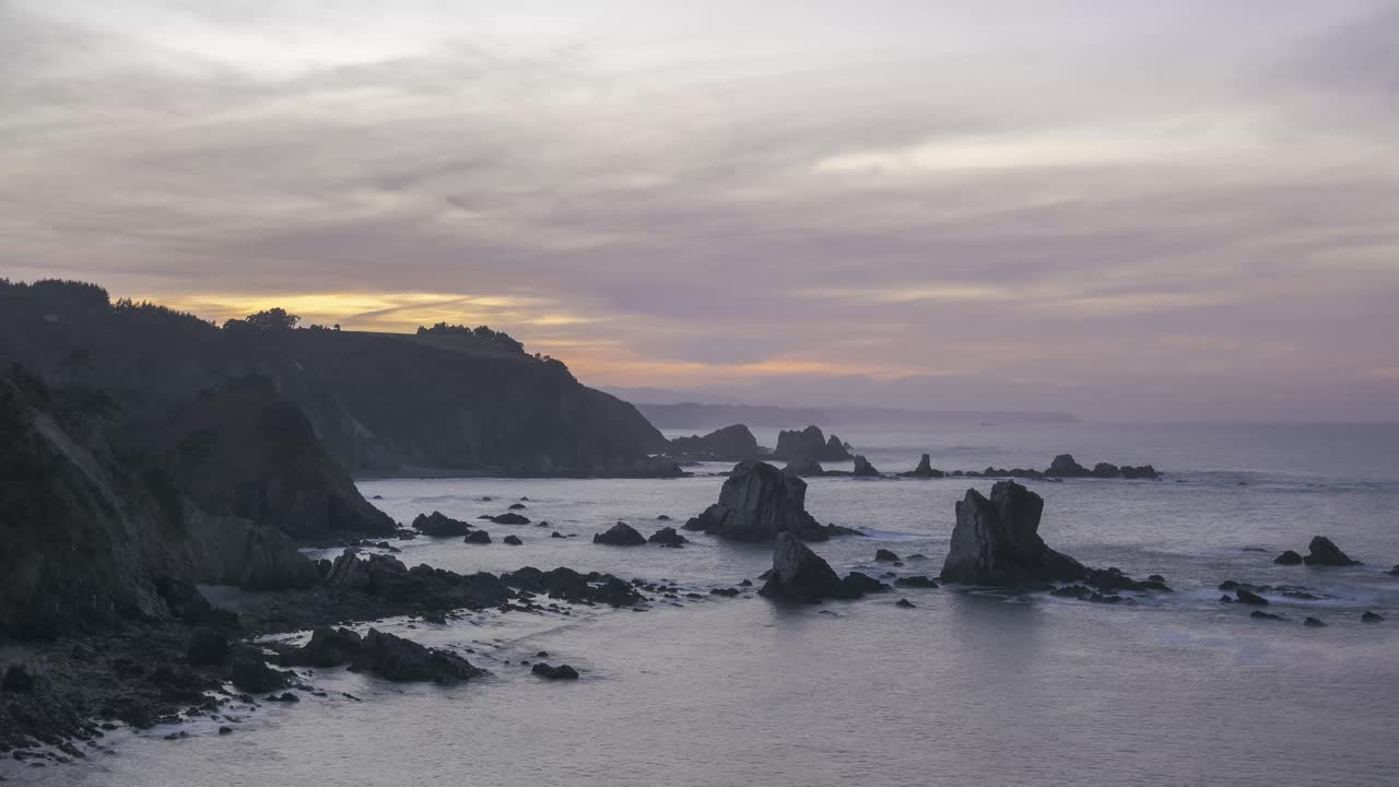 Cliffs and sea against sundown sky