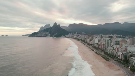 Aerial-orbit-of-an-epic-sunset-at-Leblon-beach,-the-richest-area-of-Rio-de-Janeiro-Brazil