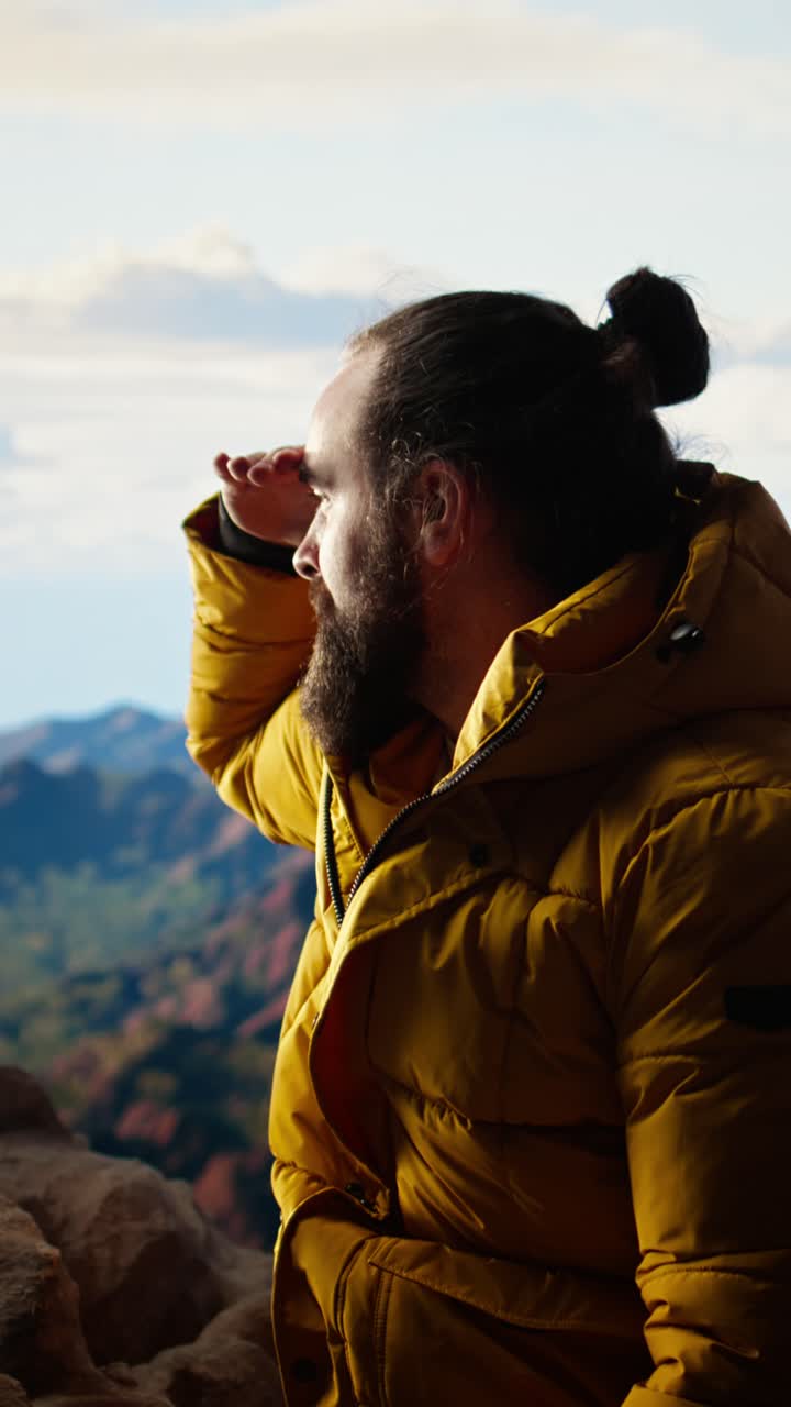 Bearded Man in Yellow Jacket Gazing at Mountain View