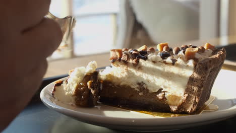 Sweet-dessert,-Banoffee-pie:-Fork-takes-delicious-slice,-closeup-view