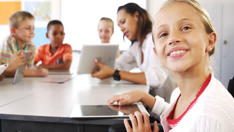 Teacher-teaching-kid-on-digital-tablet-in-library