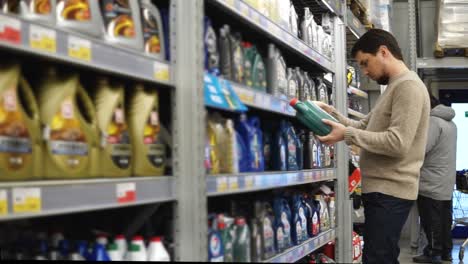 man shopping for motor oil in a store