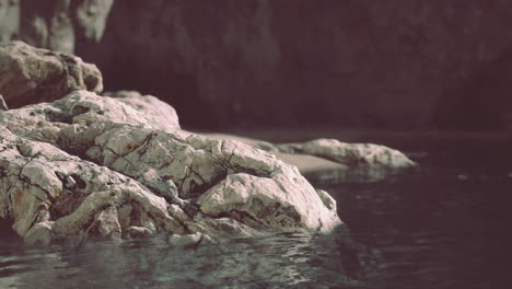tranquil coastal landscape with rocks and calm water at dusk