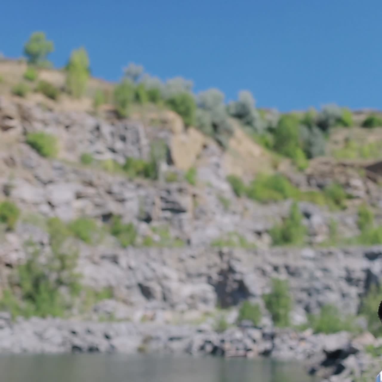 Stylish Groom Walking Alone On The Rocky Beach