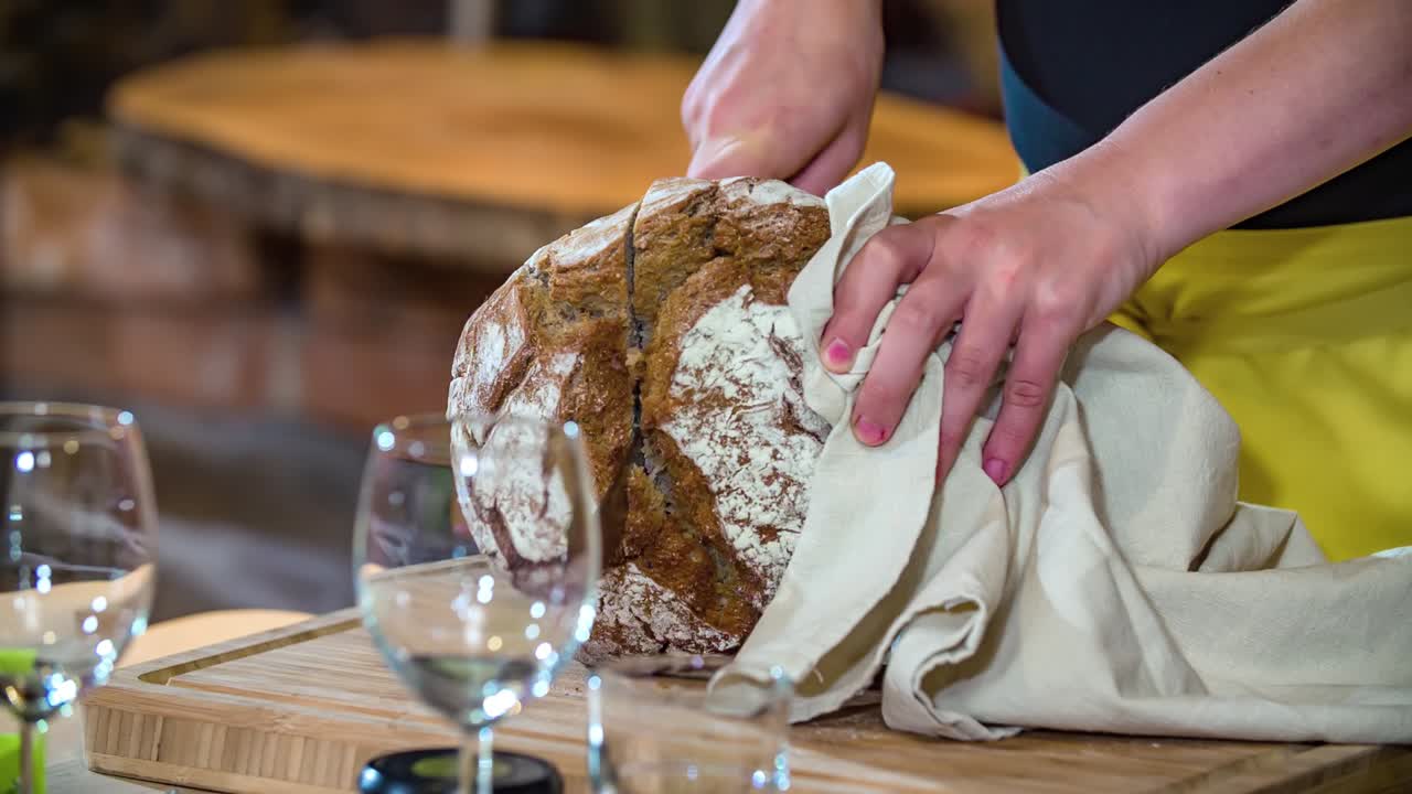 Bread knife slices through loaf of homemade bread