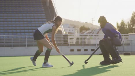 Female-hockey-players-playing-on-the-field