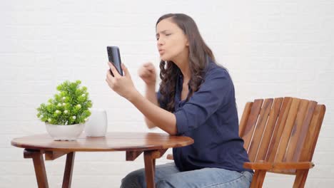 Angry-Indian-girl-talking-to-someone-on-a-video-call