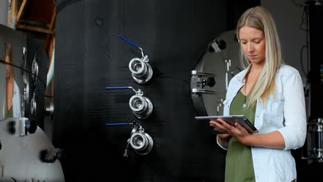 female worker using digital tablet in distillery factory 4k