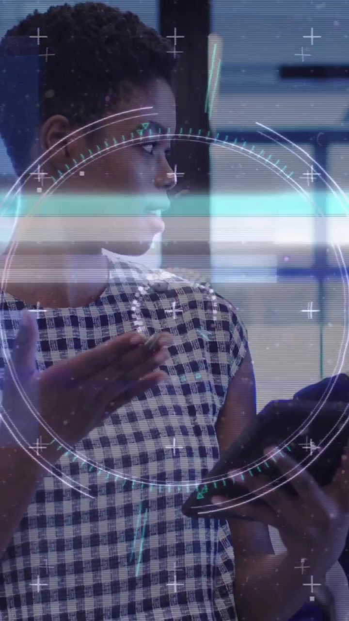 Animation of financial data processing over diverse businesswomen in office